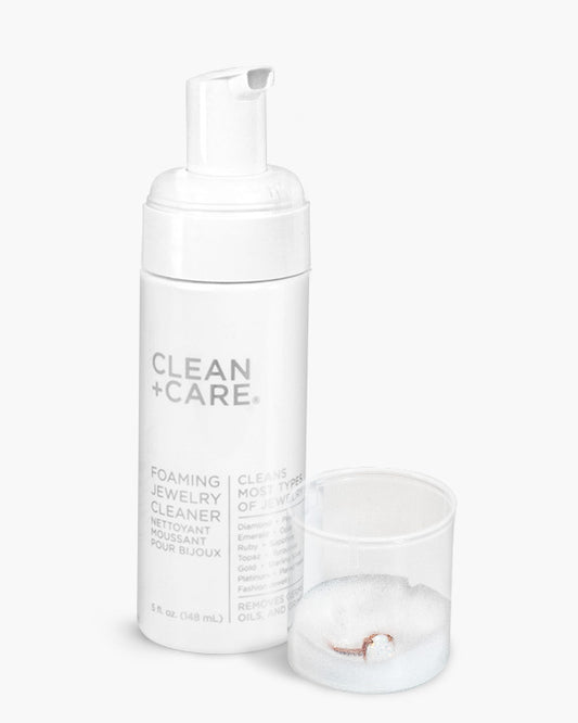 CLEAN+CARE Foaming Jewelry Cleaner with an opal ring soaking in cap