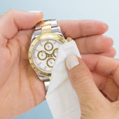 Jewelry + Watch Cleansing Wipes cleaning a gold and silver watch