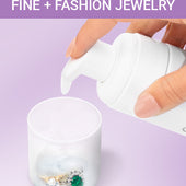CLEAN+CARE Foaming Jewelry Cleaner in-use with diamond and emerald rings being soaked in cap