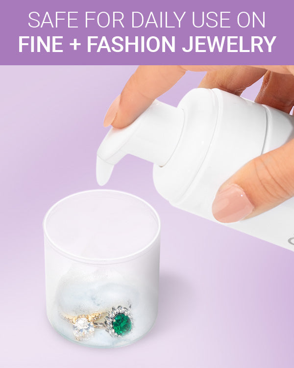 CLEAN+CARE Foaming Jewelry Cleaner in-use with diamond and emerald rings being soaked in cap