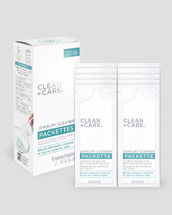 CLEAN+CARE Jewelry Cleaner Packettes box next to the 10 individual Packettes included.