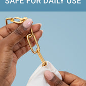 CLEAN+CARE Jewelry + Watch Cleansing Wipe in use on a gold chain