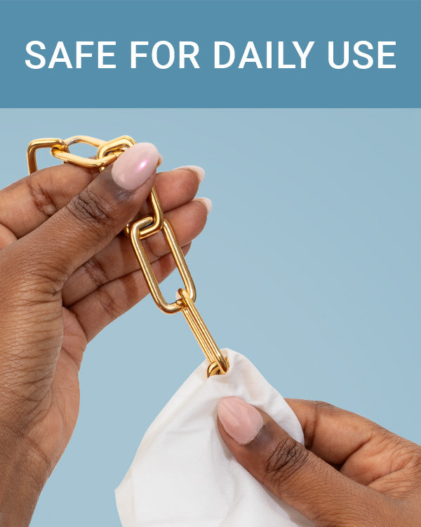 CLEAN+CARE Jewelry + Watch Cleansing Wipe in use on a gold chain