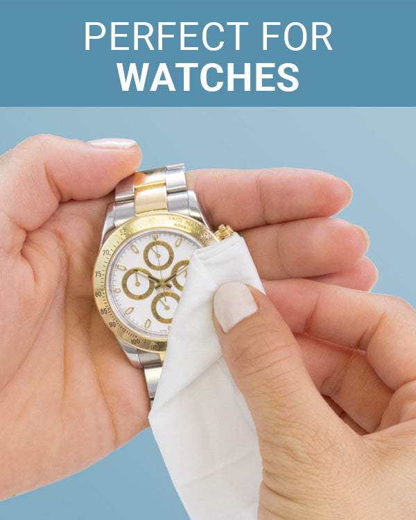 CLEAN+CARE Jewelry + Watch Cleansing Wipe in use on a gold and silver watch