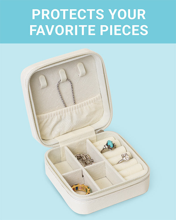 The CLEAN+CARE Jewelry Travel Case open with jewelry safely separated in different compartments for easy travel.