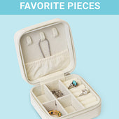 The CLEAN+CARE Jewelry Travel Case open with jewelry safely separated in different compartments for easy travel.