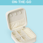 The CLEAN+CARE Jewelry Travel Case open, showing three sections with compartments that safely separate jewelry. 