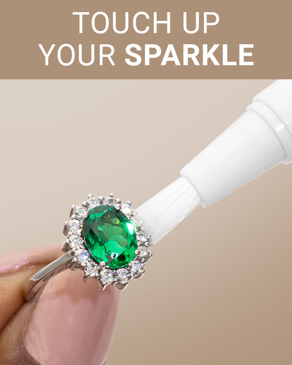 CLEAN+CARE Sparkle + Shine Jewelry Cleaning Stick in-use on an emerald ring