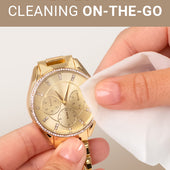 CLEAN+CARE Jewelry + Watch Cleansing Wipe in-use on a gold watch