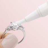 Hand holding a diamond ring and cleaning with Jewelry Cleaning Stick