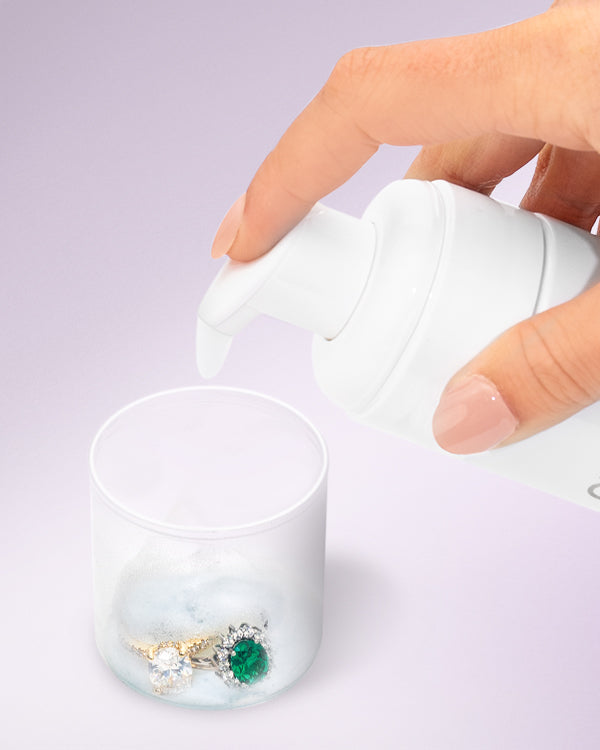 Foaming Jewelry Cleaner from Clean + Care using the lid as a ring holder for cleaning