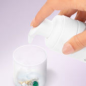 Foaming Jewelry Cleaner from Clean + Care using the lid as a ring holder for cleaning