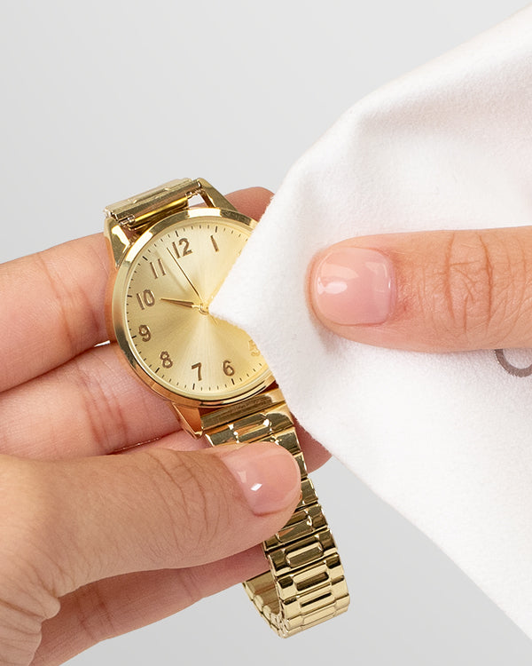 Hands holding a gold watch and polishing with a Microfiber Cleaning Cloth