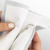 Hands polishing a diamond ring with a Polishing Cloth