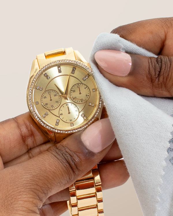 Clean + Care Polishing Cloth cleaning a gold watch